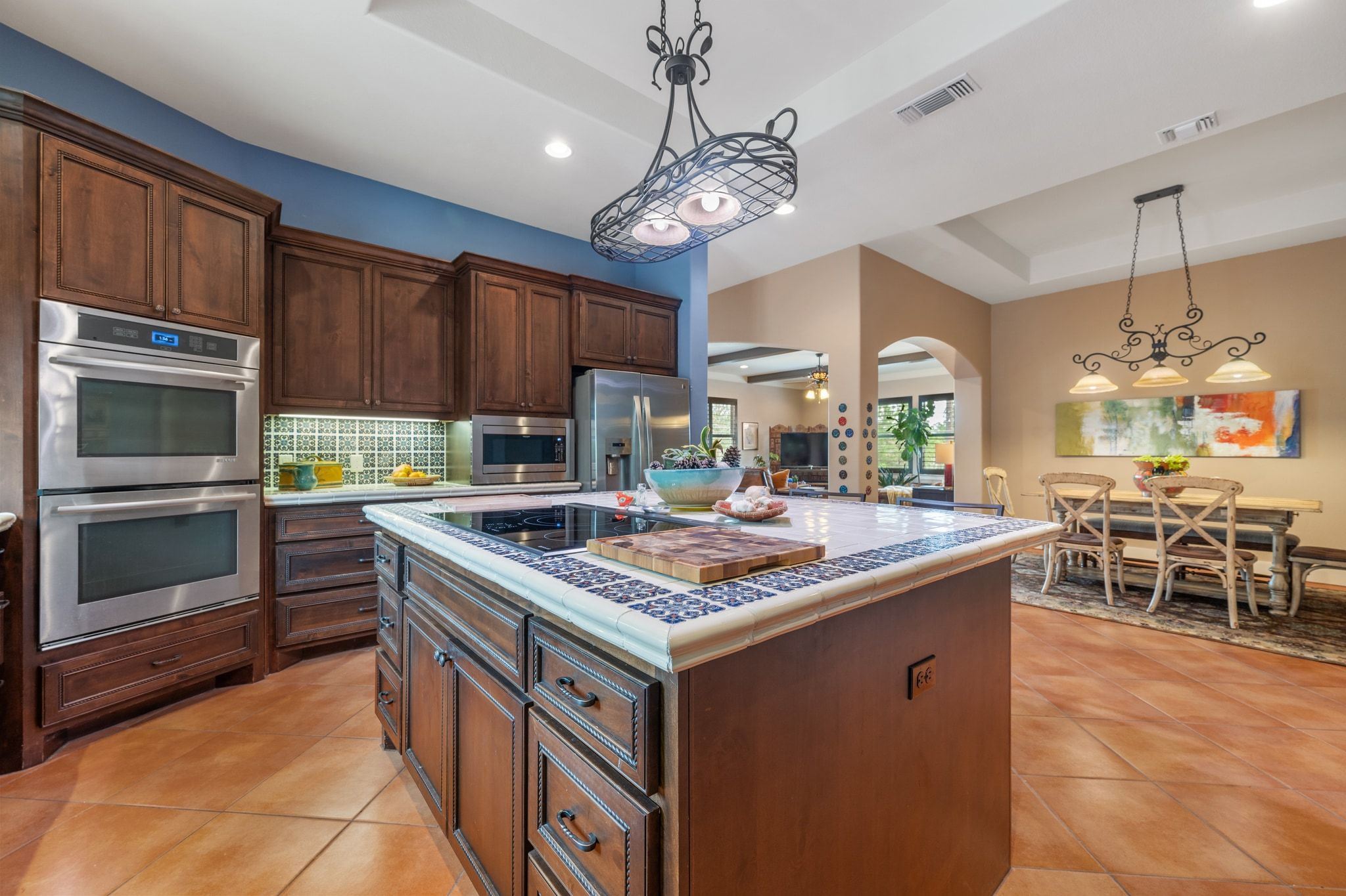 129 Painted Post Bastrop, TX 78602 - Photo 17 of 40 Featuring built-in stainless steel applianced including an electric cooktop on the island, built-in double wall ovens, a microwave, dishwasher, and the fridge.