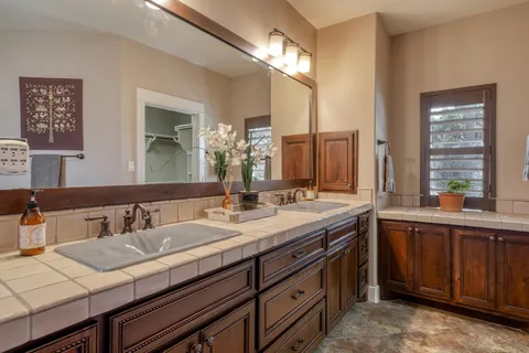 a bathroom with a sink double vanity and a mirror
