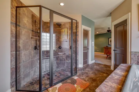 a en suite bathroom with a shower and a sink