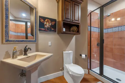 a bathroom with a toilet a sink and a mirror