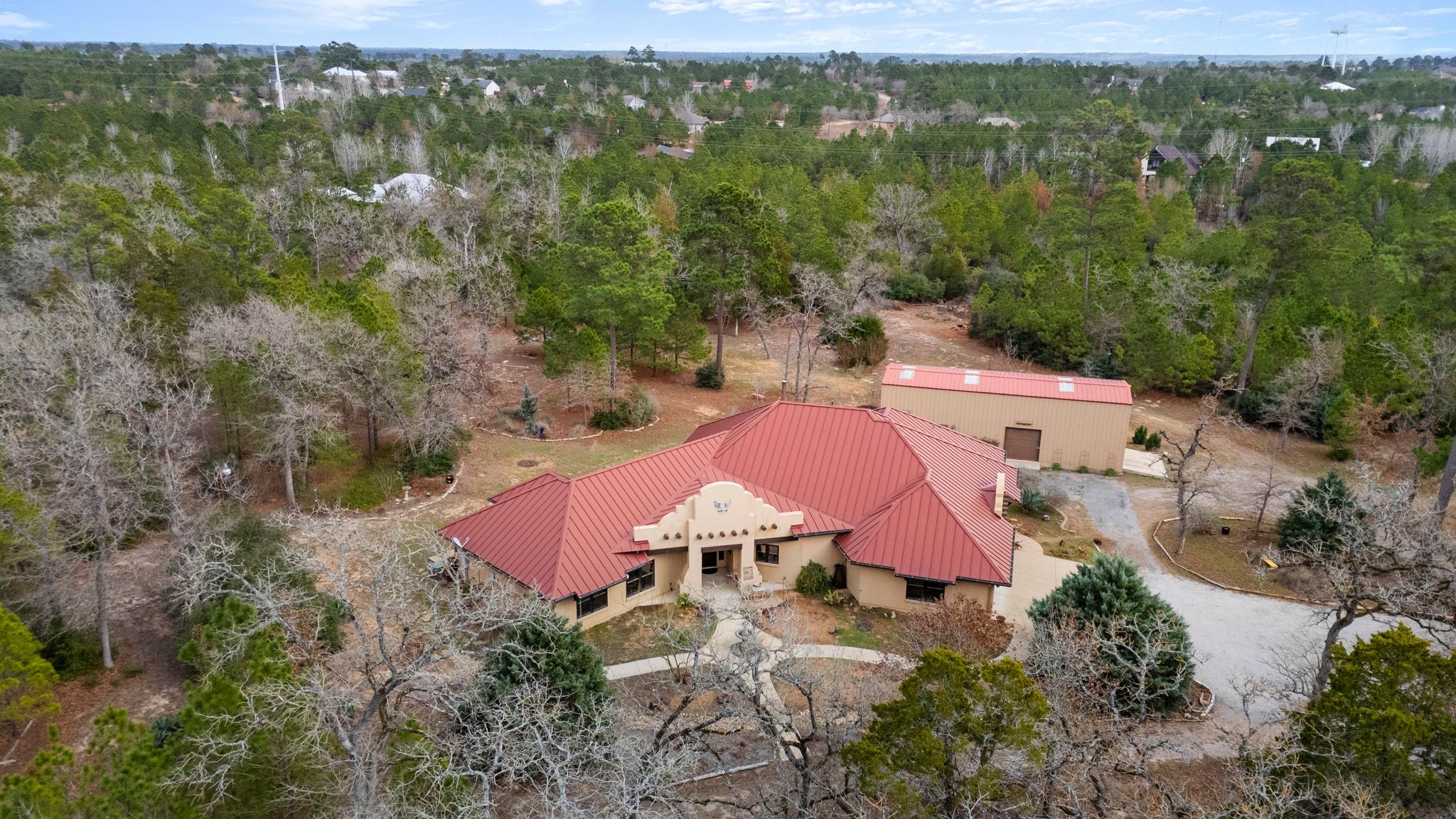 129 Painted Post Bastrop, TX 78602 - Photo 6 of 40 Peacefully secluded away just a few minutes’ drive from north shore access to Lake Bastrop, this exquisite luxury residence is surrounded by private expansive acreage filled with serene pines and native foliage.