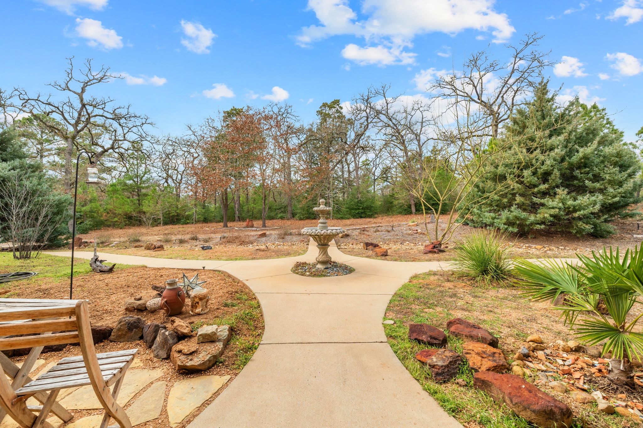 129 Painted Post Bastrop, TX 78602 - Photo 10 of 40 The front patio and courtyard walkway is surrounded by mature natural landscaping with a serene fountain to welcome you home.