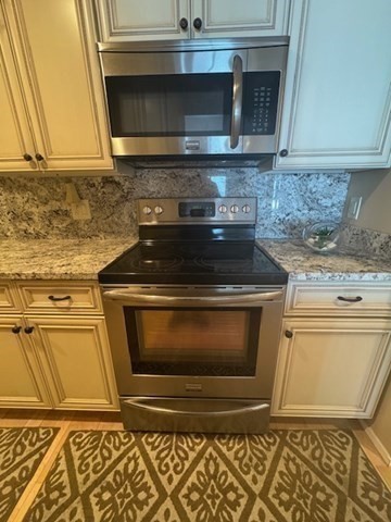 1 Seal Harbor Road, Unit 210 Winthrop, MA 02152 - Photo 13 of 27 a stove top oven sitting inside of a kitchen