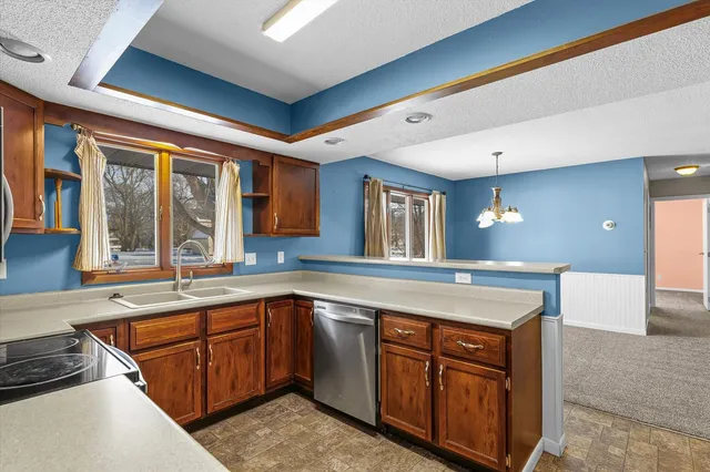 a kitchen with a sink stove and cabinets