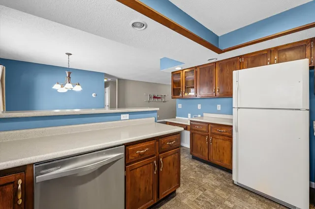 a kitchen with a refrigerator a sink and cabinets