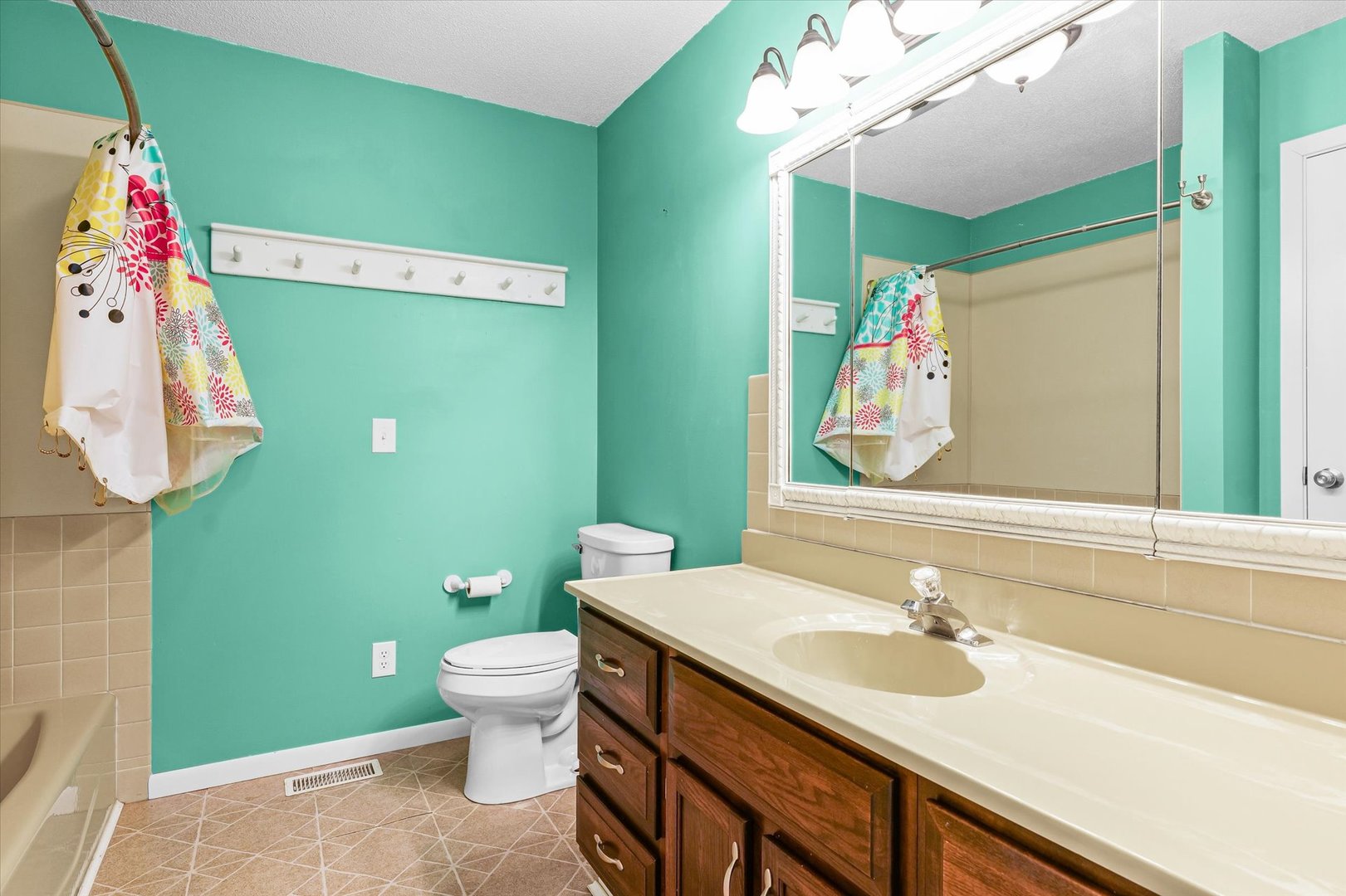 211 North Center Street Melvin, IL 60952 - Photo 13 of 26 a bathroom with a sink vanity mirror and toilet