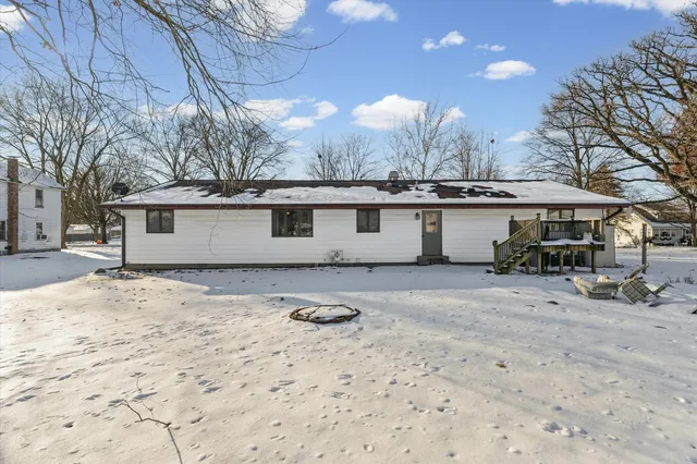 a view of a house with a snow in the yard