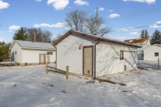 a view of a house with a snow in the background