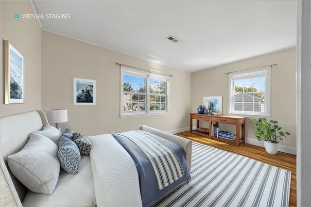a view of a room with wooden floor and windows