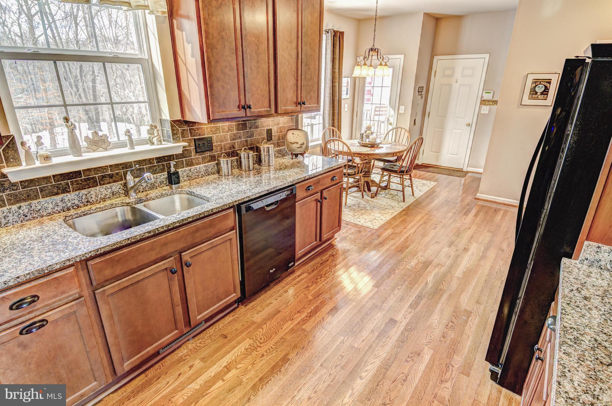 2106 Baythorne Road Prince Frederick, MD 20678 - Photo 14 of 30 a large kitchen with granite countertop a sink a counter space and a window