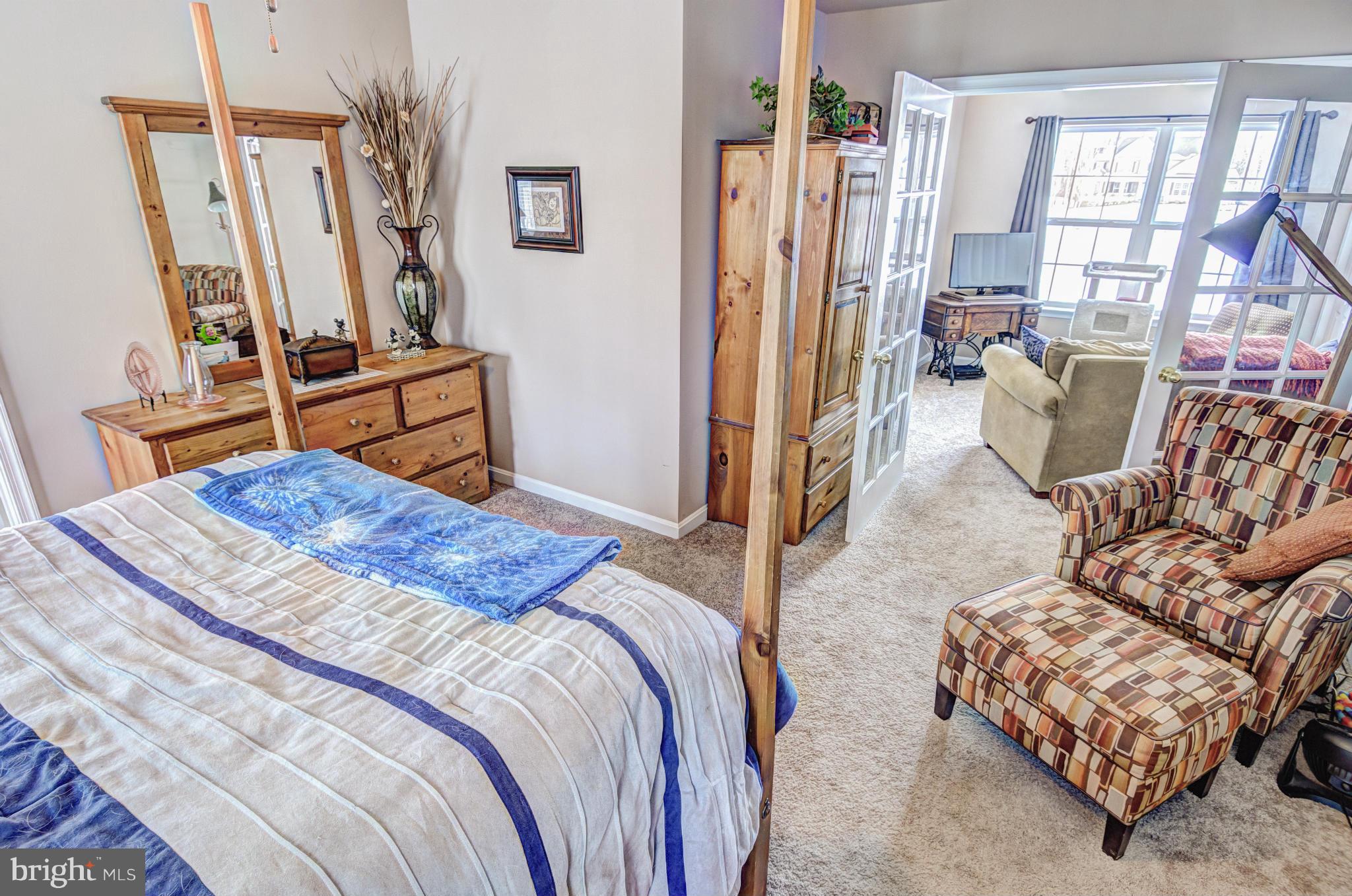 2106 Baythorne Road Prince Frederick, MD 20678 - Photo 16 of 30 a bedroom with bed and wooden floor