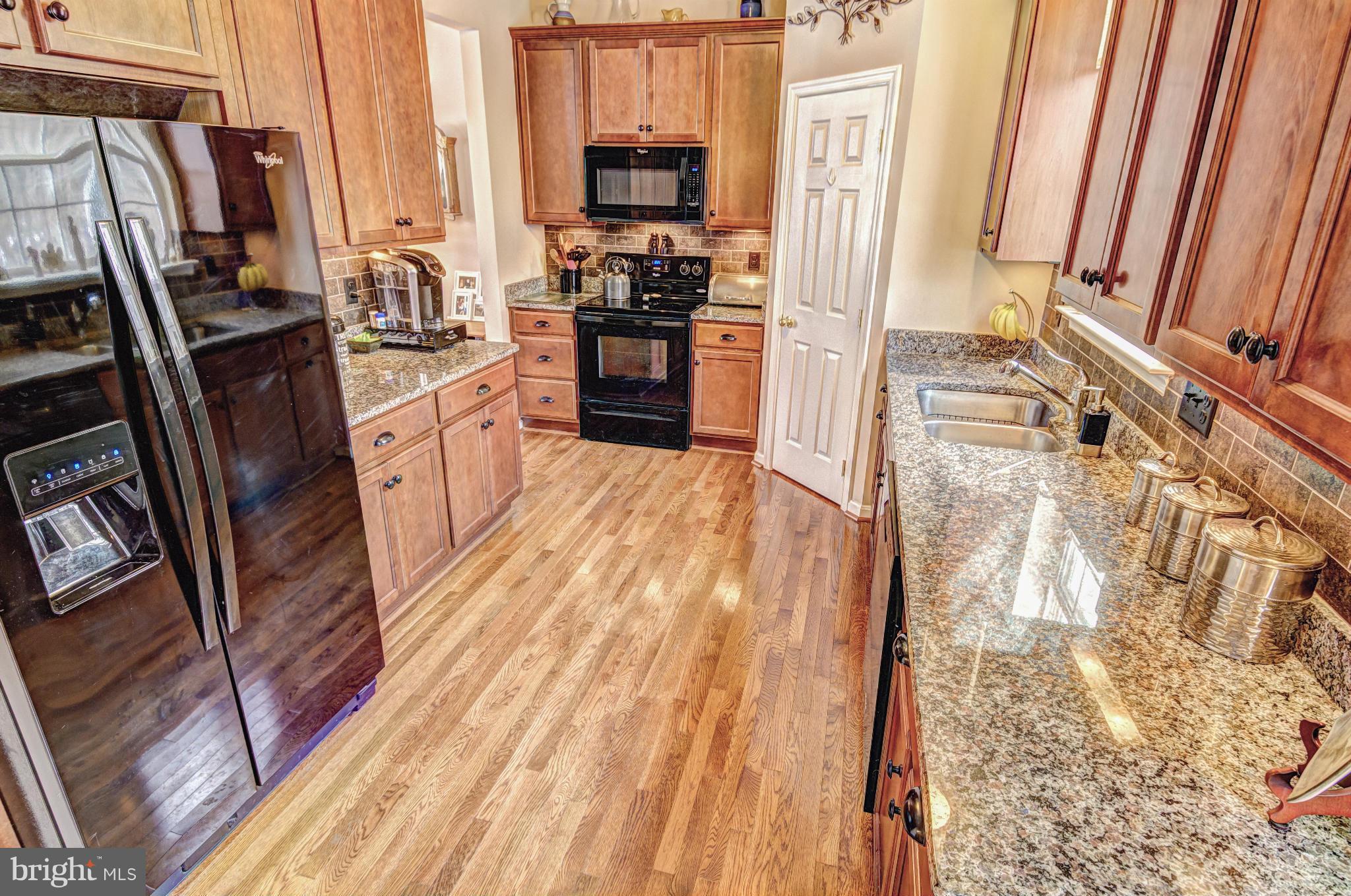 2106 Baythorne Road Prince Frederick, MD 20678 - Photo 3 of 30 a kitchen with stainless steel appliances a refrigerator a stove top oven a sink and dishwasher