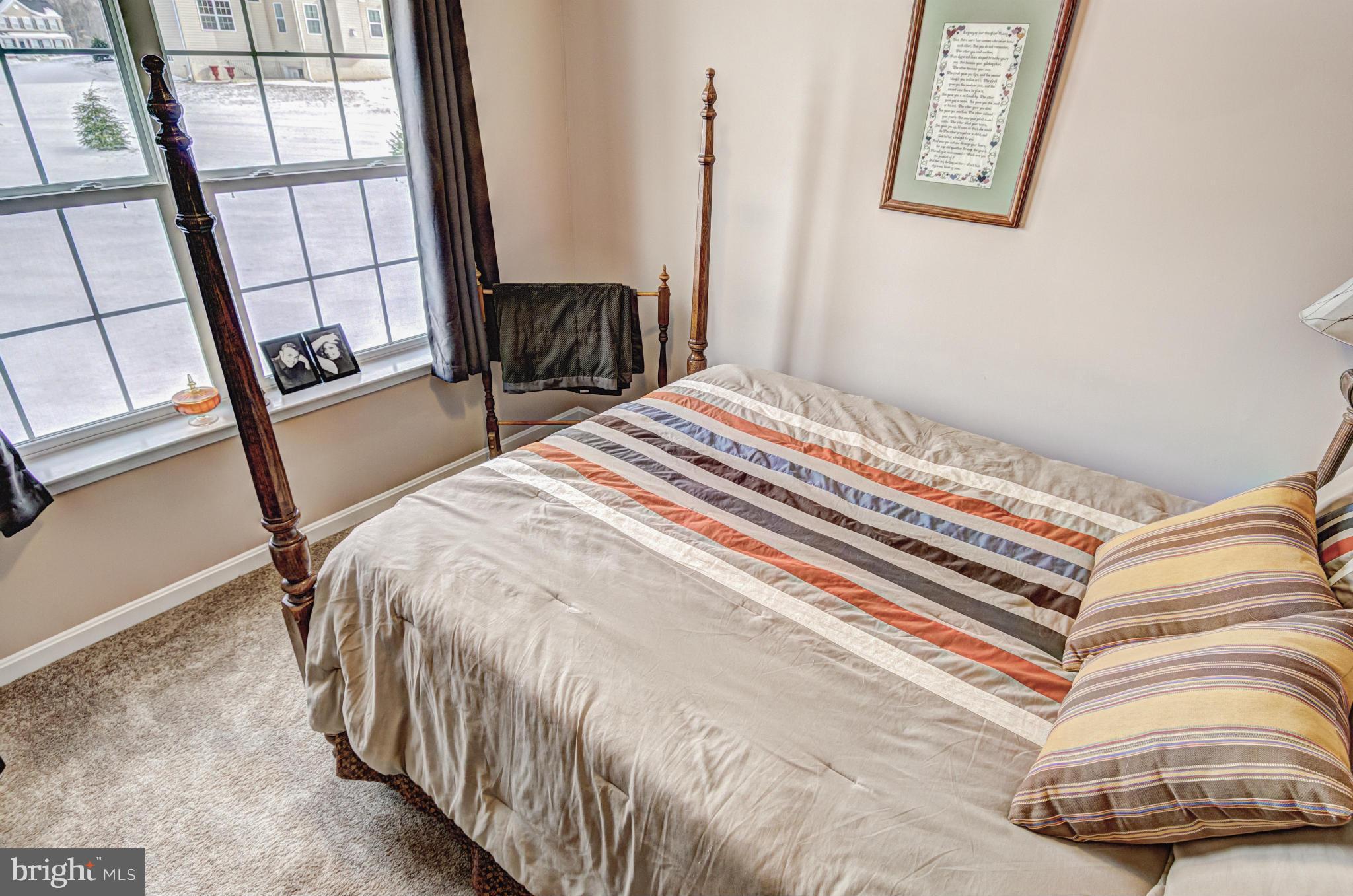 2106 Baythorne Road Prince Frederick, MD 20678 - Photo 24 of 30 a bedroom with a bed and a large window