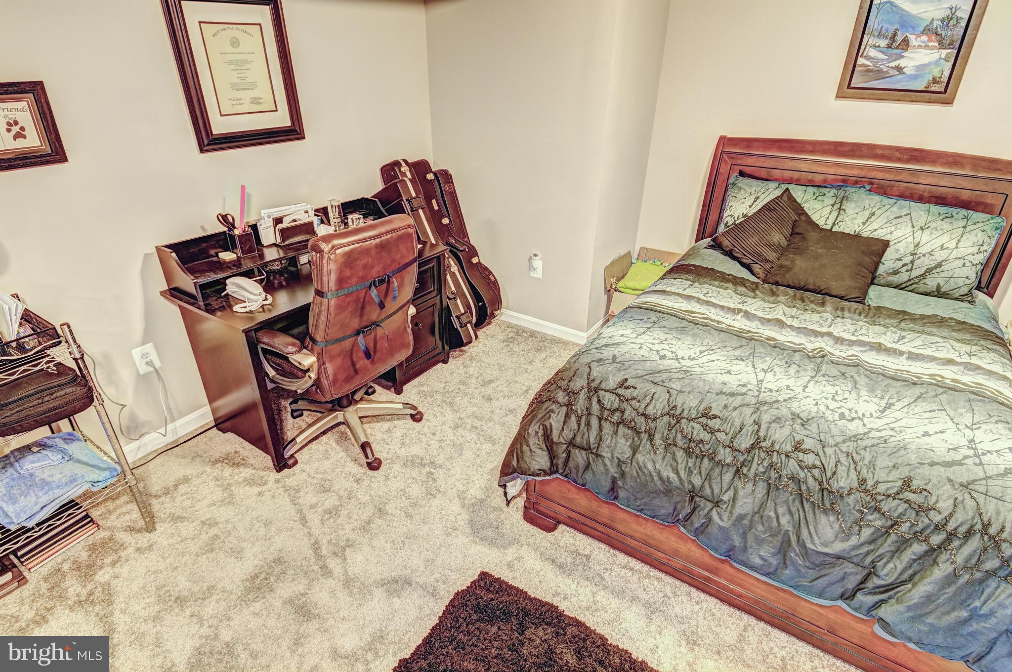 2106 Baythorne Road Prince Frederick, MD 20678 - Photo 28 of 30 a bed sitting in a bedroom next to a window