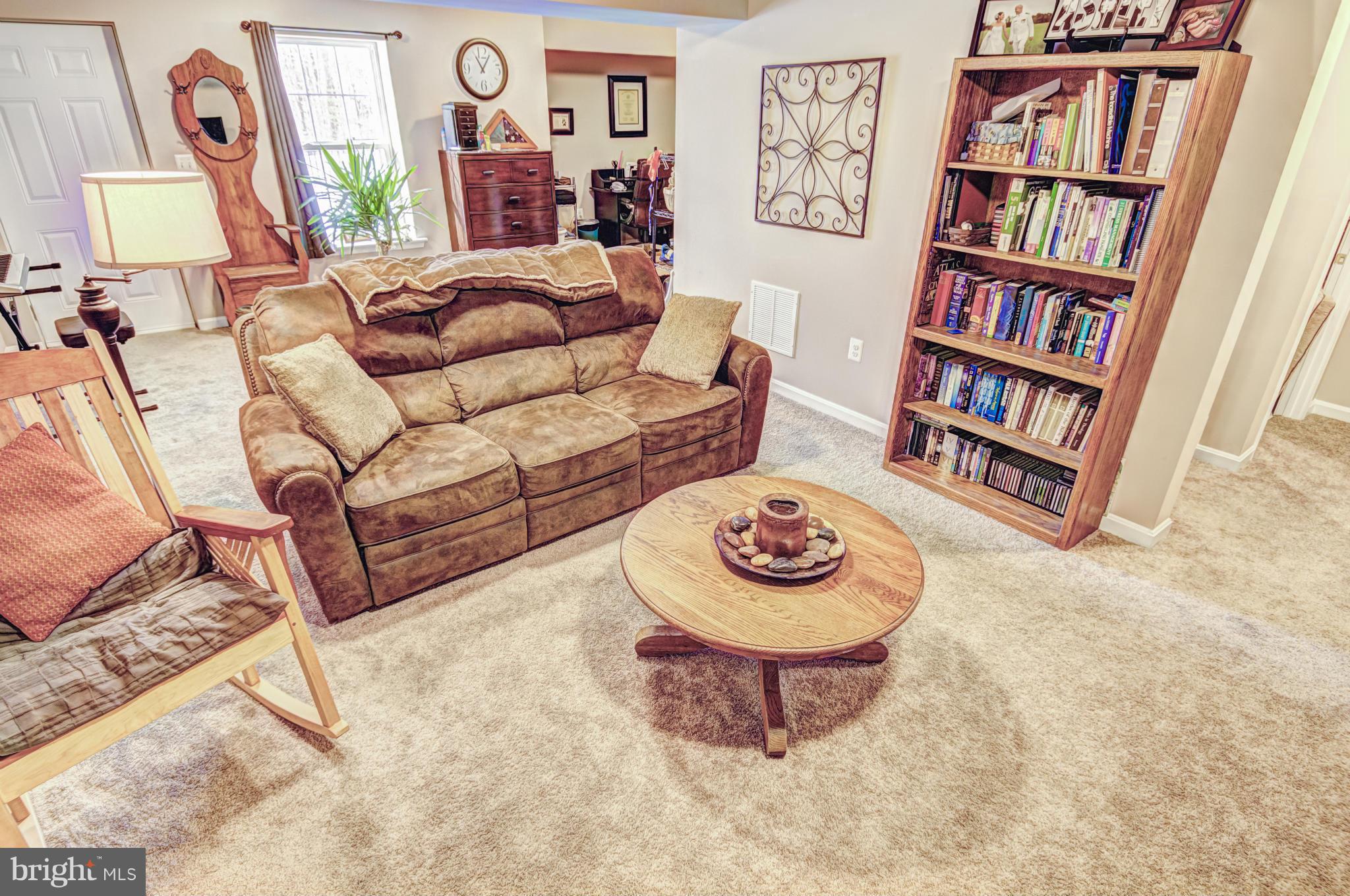 2106 Baythorne Road Prince Frederick, MD 20678 - Photo 5 of 30 a living room with furniture and a book shelf