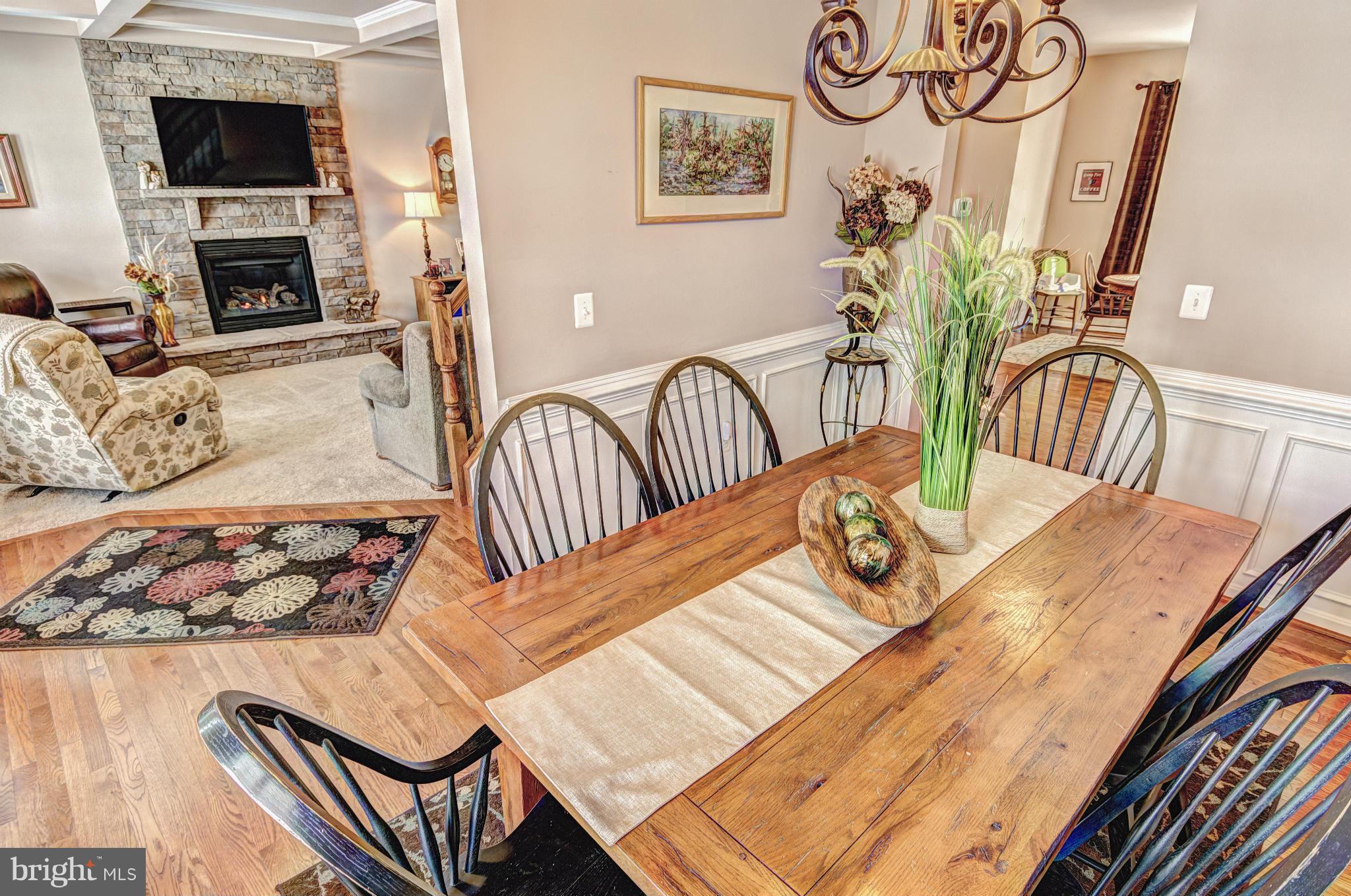 2106 Baythorne Road Prince Frederick, MD 20678 - Photo 7 of 30 a view of a dining room with furniture a fireplace and wooden floor