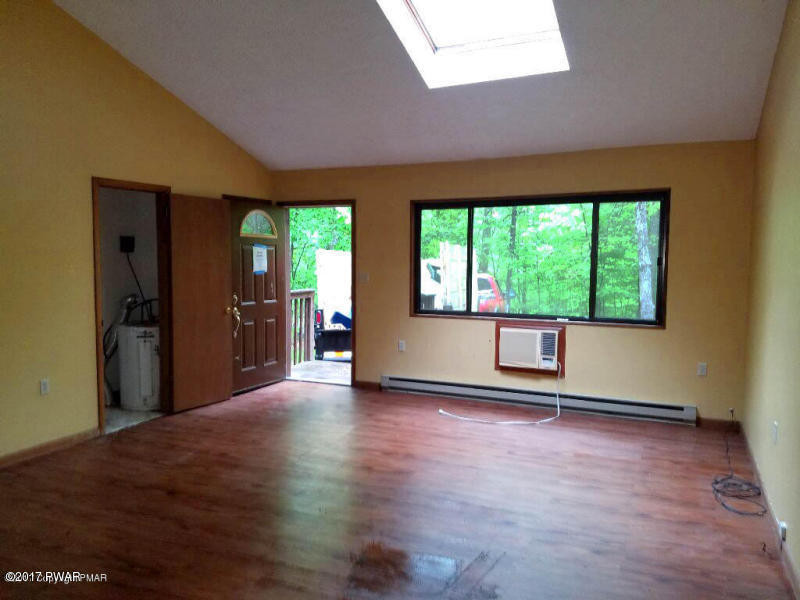 16 Pheasant Run Bushkill, PA 18324 - Photo 3 of 11 wooden floor in an empty room with a window