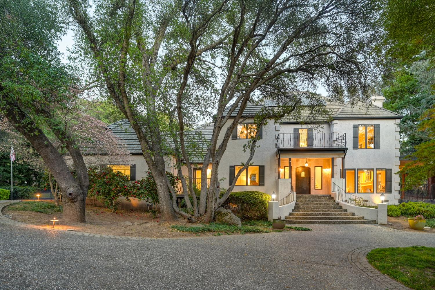 4911 Lexington Circle Loomis, CA 95650 - Photo 1 of 48 a front view of a house with a garden and trees