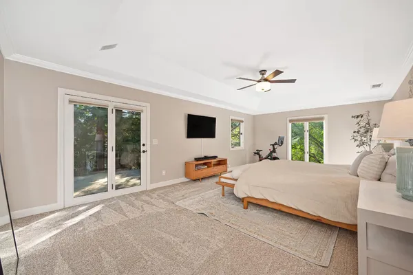 a bedroom with a bed and a large window with the outer view