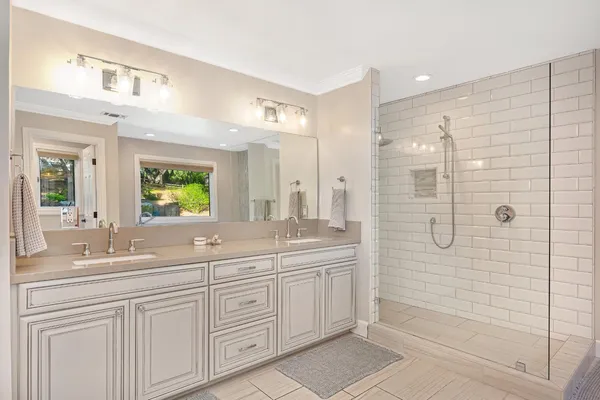 a bathroom with a shower sink and mirror