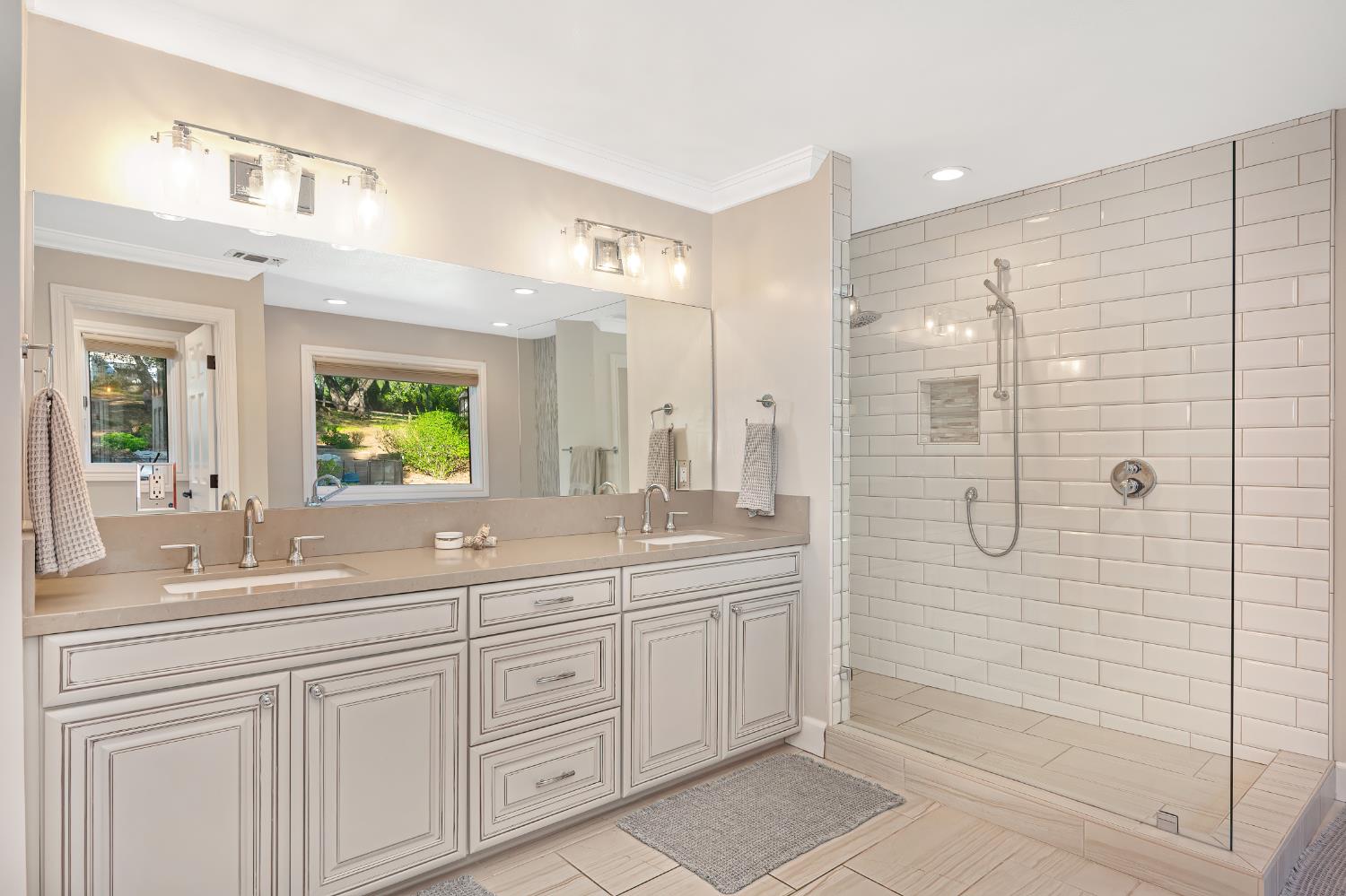 4911 Lexington Circle Loomis, CA 95650 - Photo 16 of 48 a bathroom with a shower sink and mirror