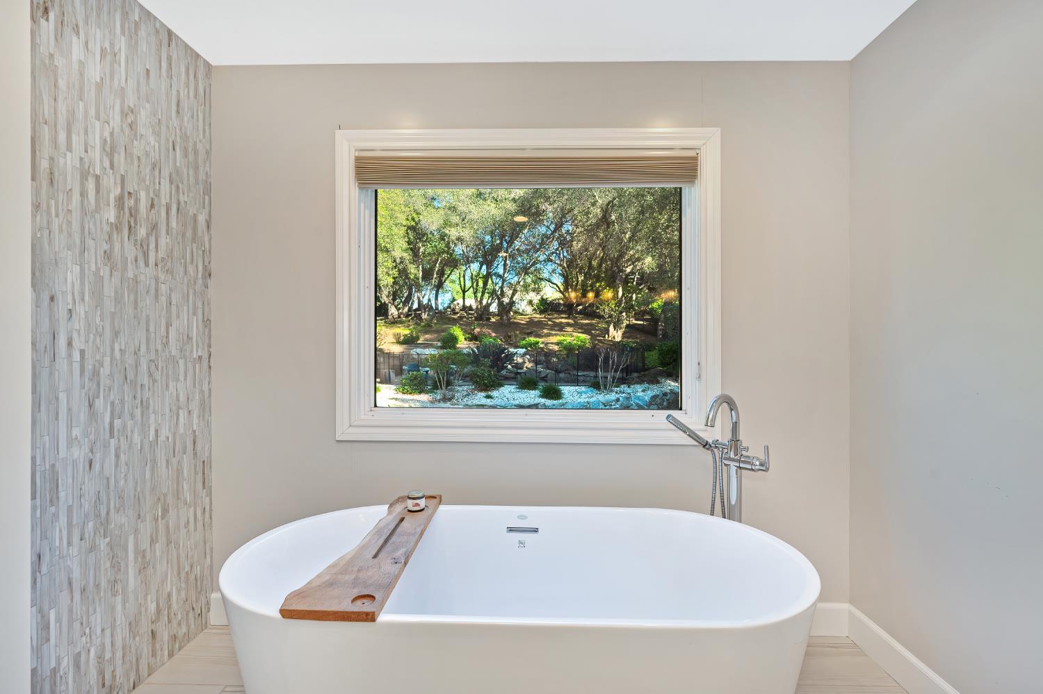 4911 Lexington Circle Loomis, CA 95650 - Photo 18 of 48 a white bath tub sitting in a bathroom next to a window