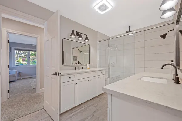 a spacious bathroom with a sink and a mirror