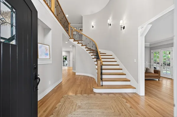 a view of entryway and hall with wooden floor