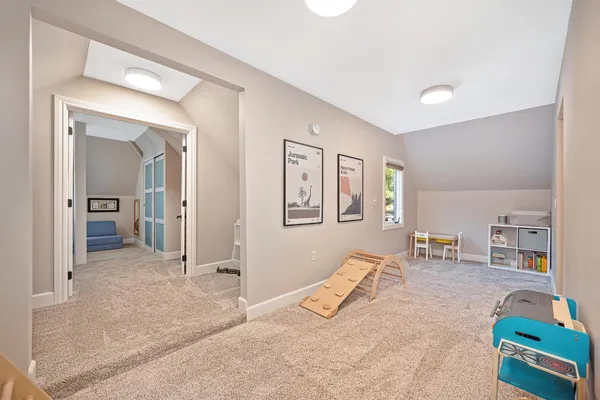 a view of a livingroom with wooden floor and furniture