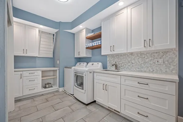 a kitchen with granite countertop white cabinets and white appliances