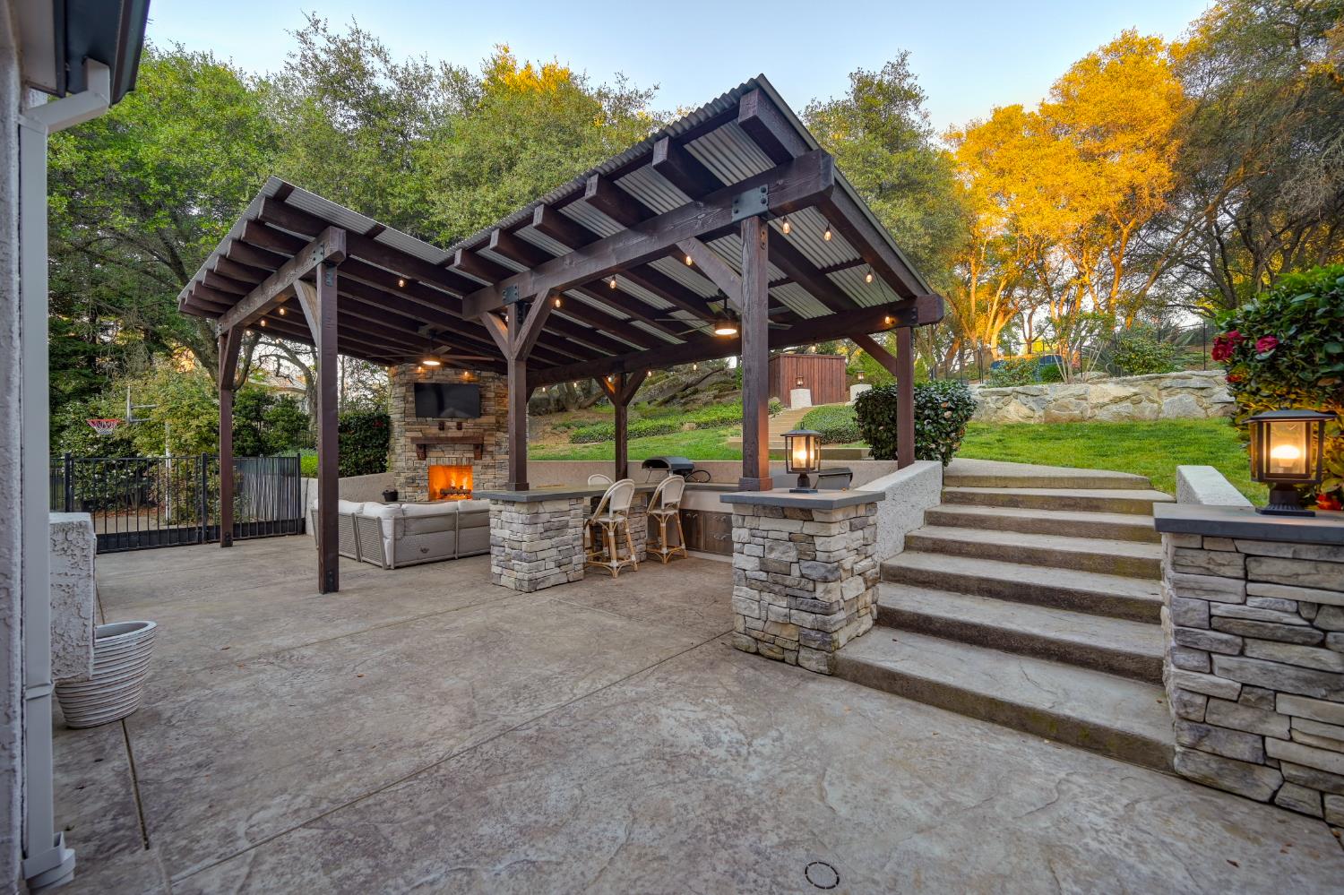 4911 Lexington Circle Loomis, CA 95650 - Photo 28 of 48 a view of a patio with table and chairs a barbeque with wooden fence