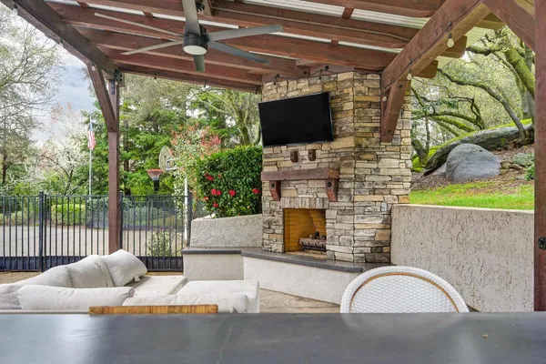 a living room with fireplace furniture and a flat screen tv