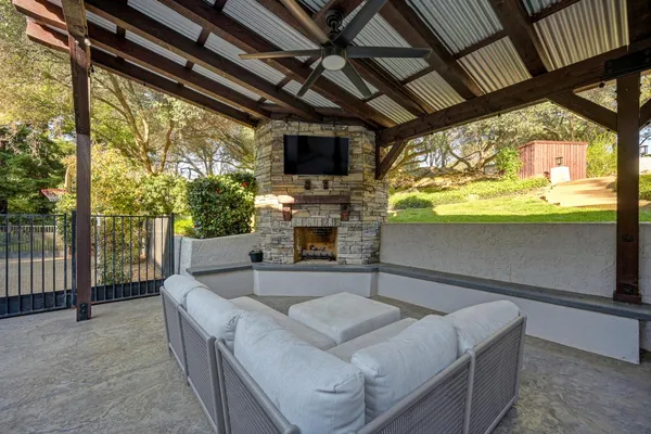 a living room with fireplace furniture and a flat screen tv