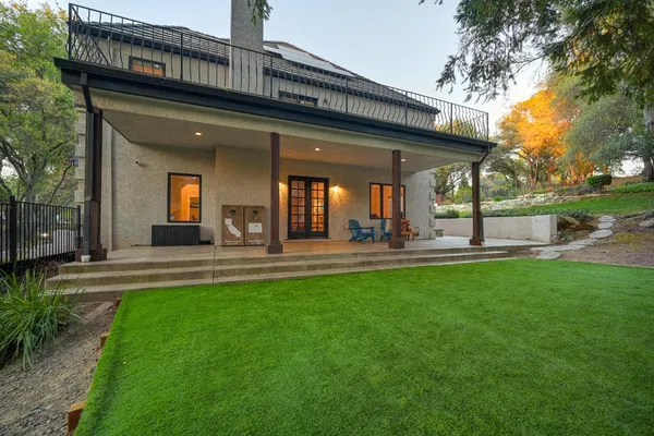 a front view of a house with patio and garden