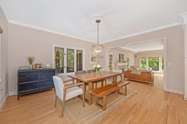 a living room with furniture dining table and a chandelier