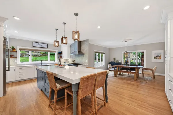 a view of kitchen with stainless steel appliances granite countertop cabinets and wooden floor