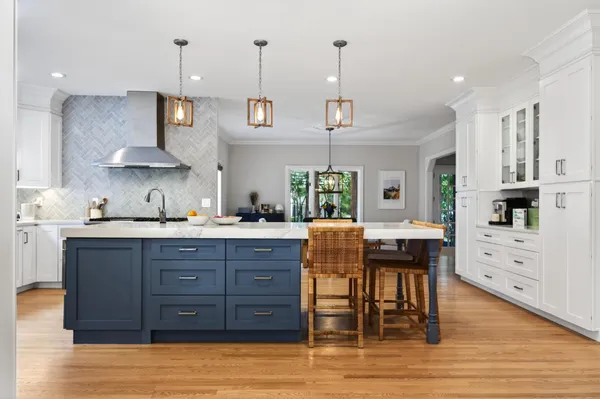 a kitchen with stainless steel appliances kitchen island granite countertop a sink and cabinets