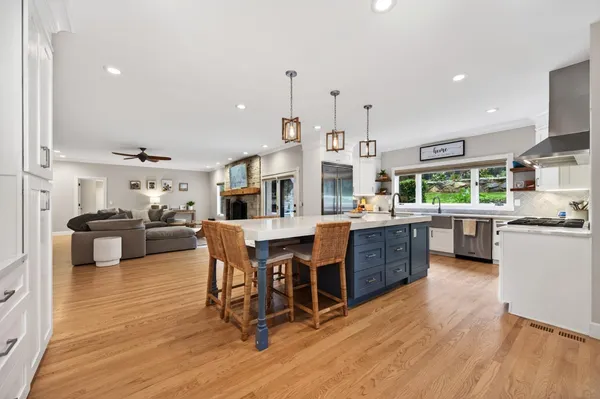a large kitchen with a table and chairs in it