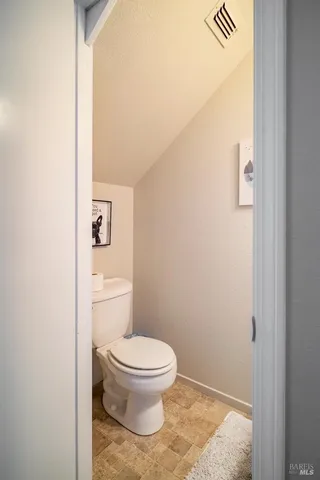 a white toilet sitting next to a shower
