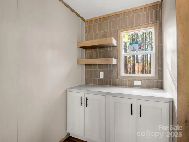 a kitchen with a sink cabinets and a window