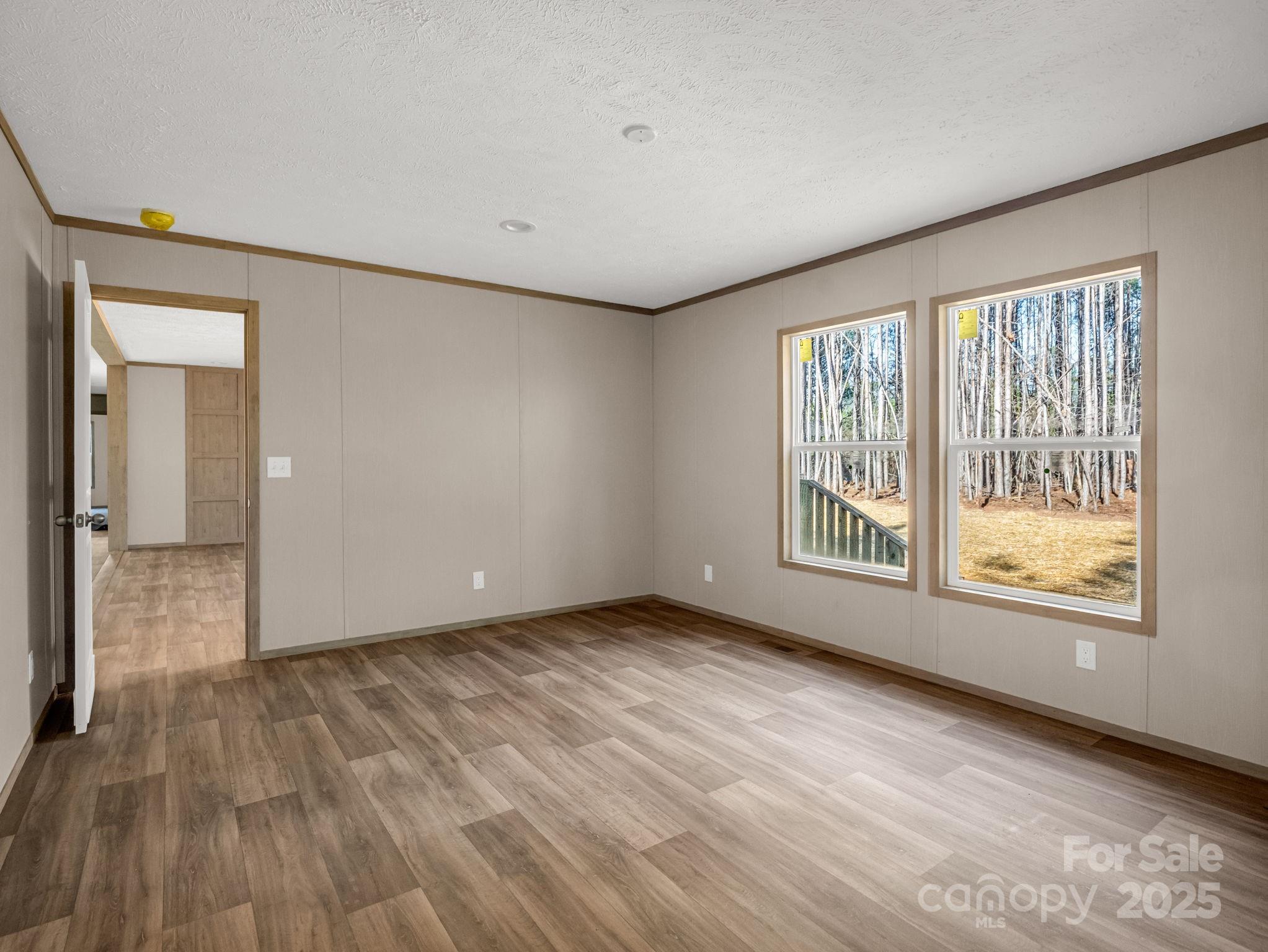 864 Tiney Road Ellenboro, NC 28040 - Photo 16 of 33 a view of an empty room with wooden floor and a window