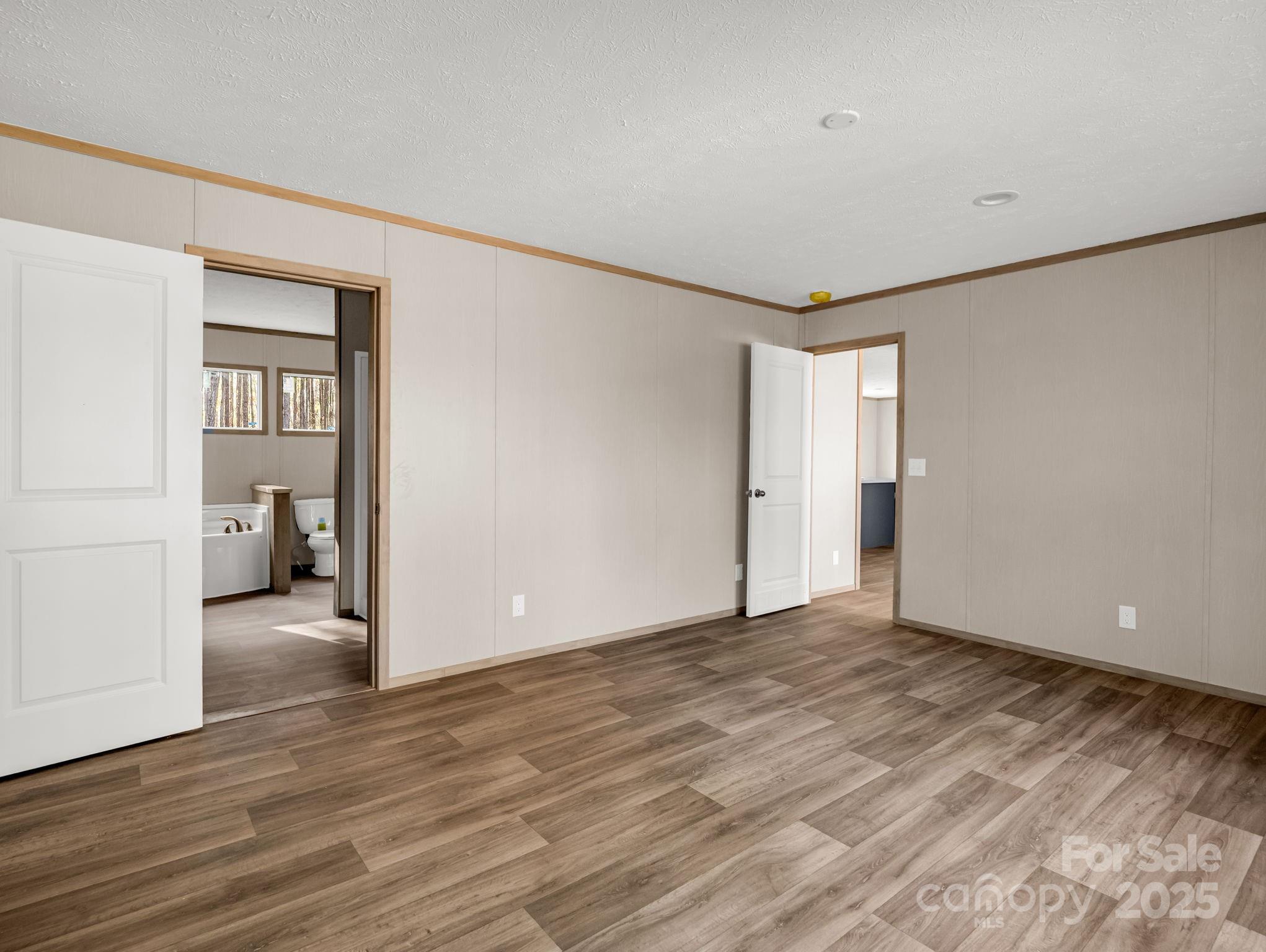 864 Tiney Road Ellenboro, NC 28040 - Photo 17 of 33 a view of an empty room with wooden floor and a window