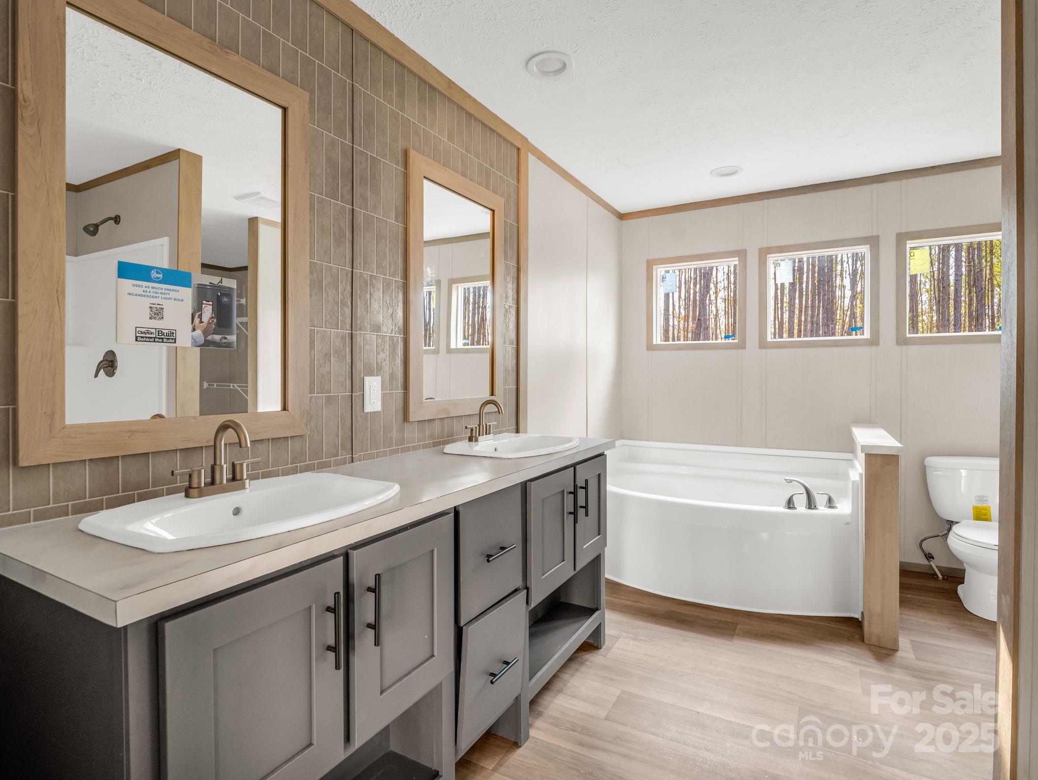 864 Tiney Road Ellenboro, NC 28040 - Photo 18 of 33 a spacious bathroom with a double vanity sink a mirror and a bathtub