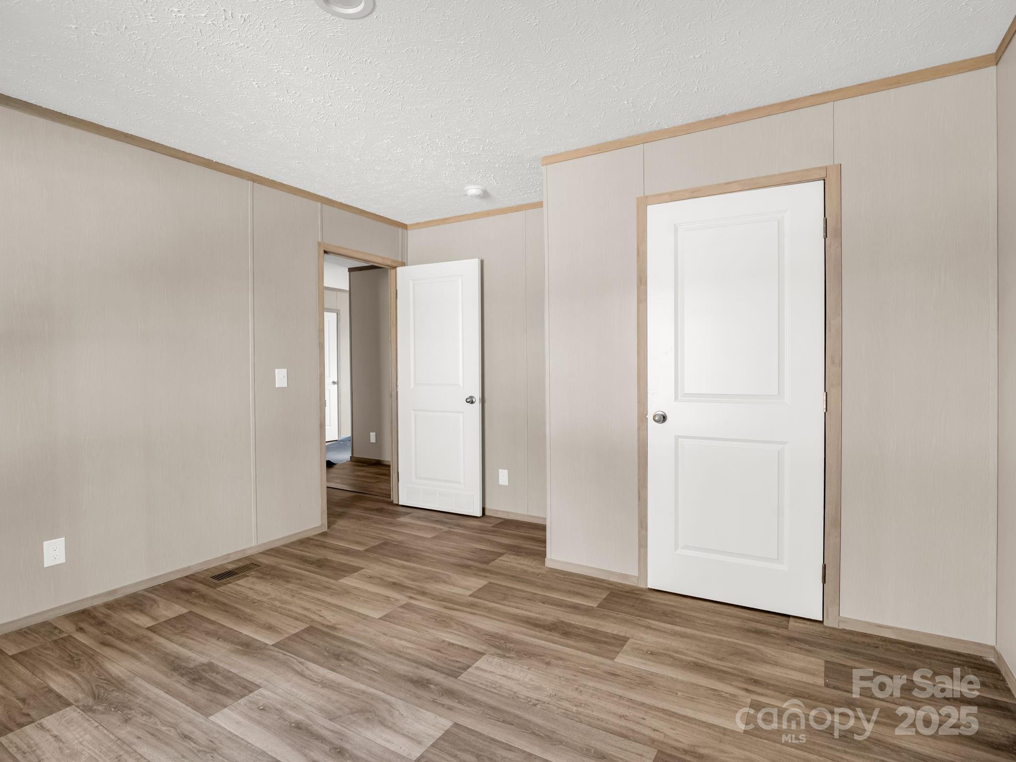 864 Tiney Road Ellenboro, NC 28040 - Photo 24 of 33 a view of an empty room with wooden floor