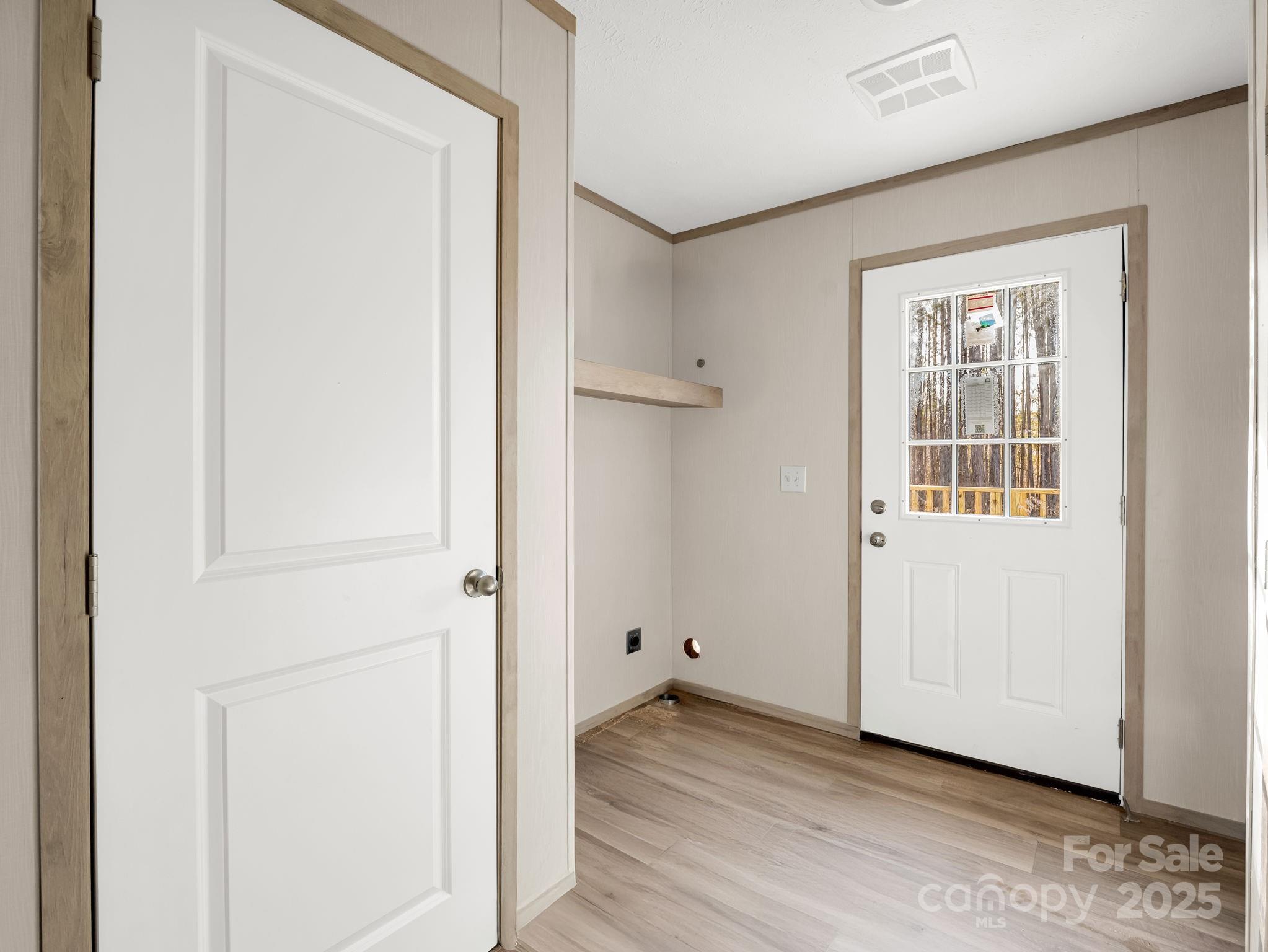 864 Tiney Road Ellenboro, NC 28040 - Photo 28 of 33 a view of an empty room with wooden floor and a window