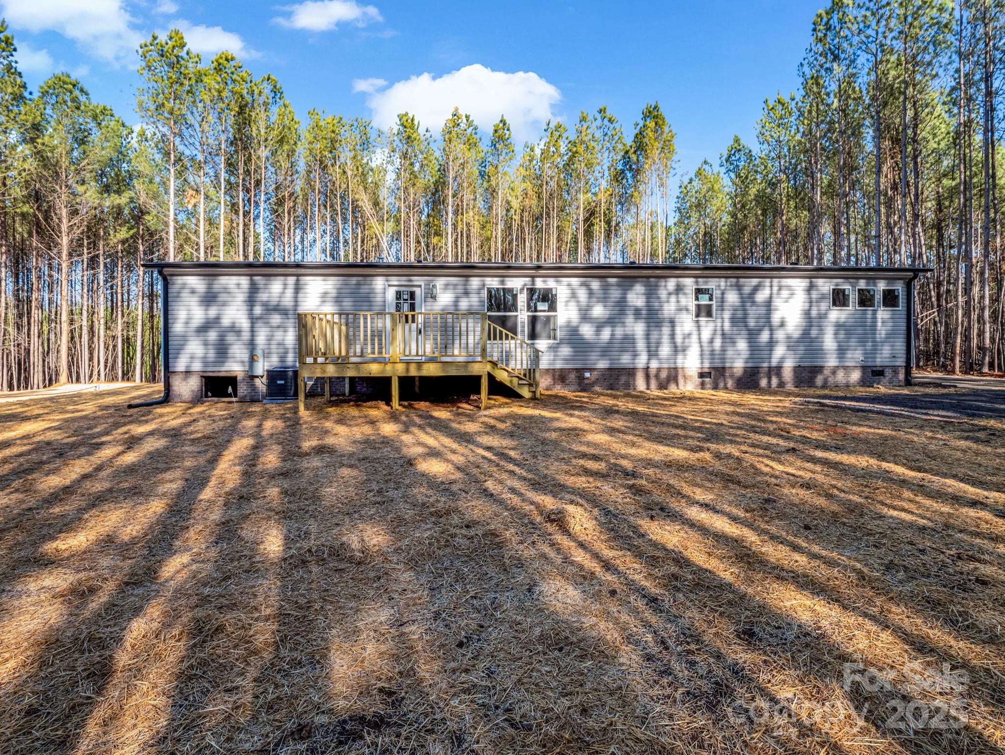 864 Tiney Road Ellenboro, NC 28040 - Photo 5 of 33 a backyard of a house with table and chairs