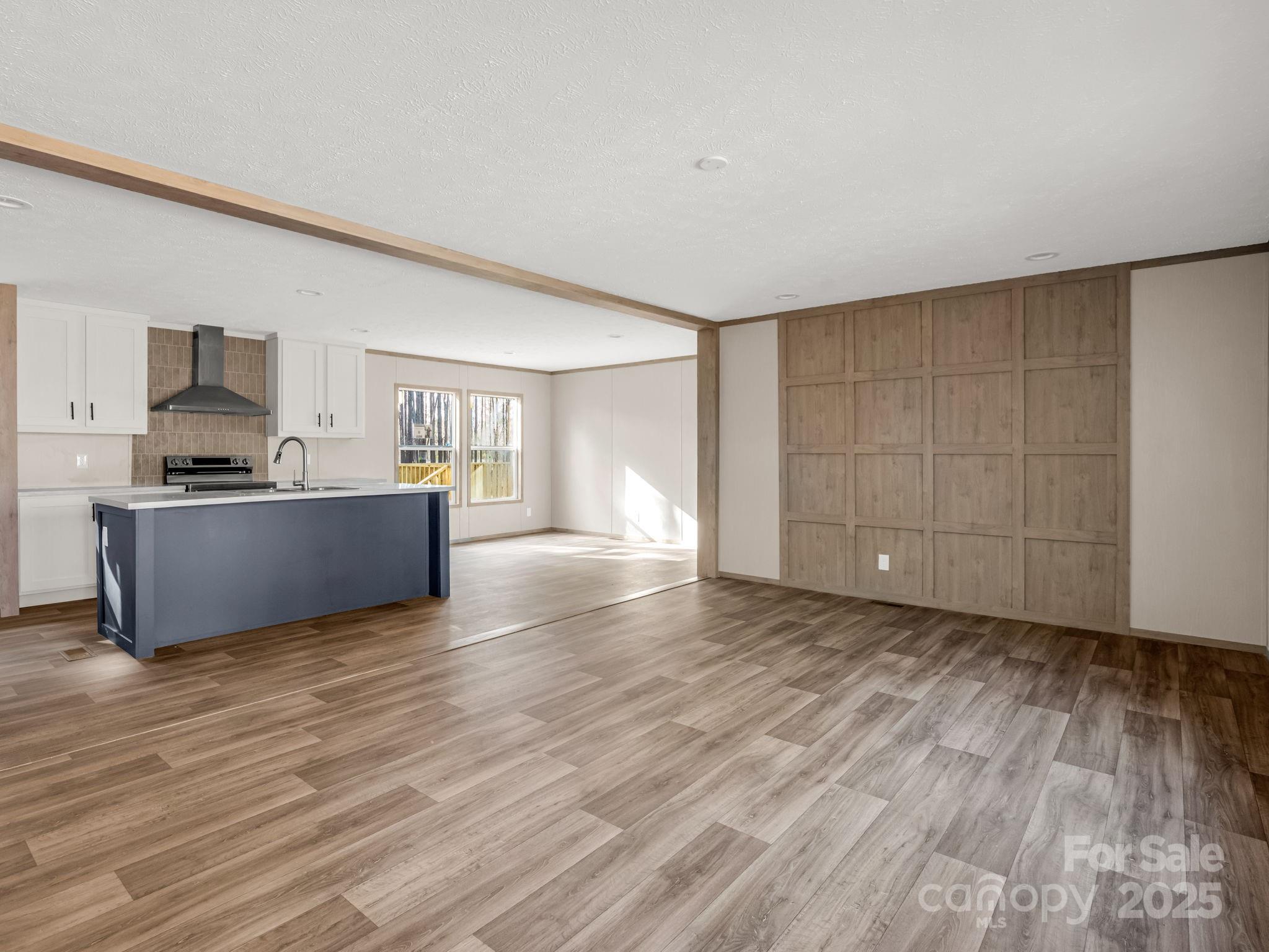 864 Tiney Road Ellenboro, NC 28040 - Photo 8 of 33 a view of empty room with wooden floor and cabinet