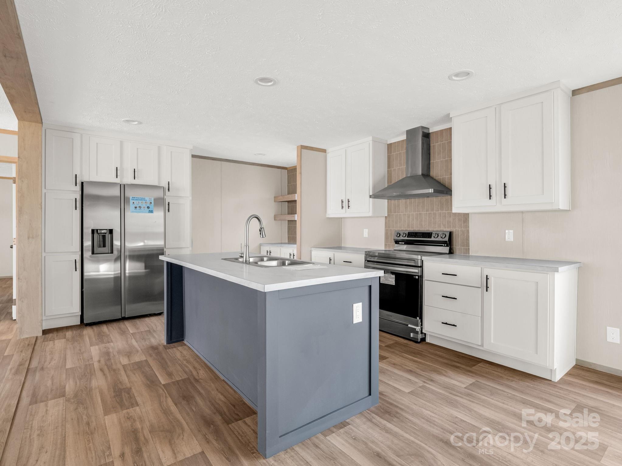 864 Tiney Road Ellenboro, NC 28040 - Photo 9 of 33 a kitchen with kitchen island white cabinets and stainless steel appliances