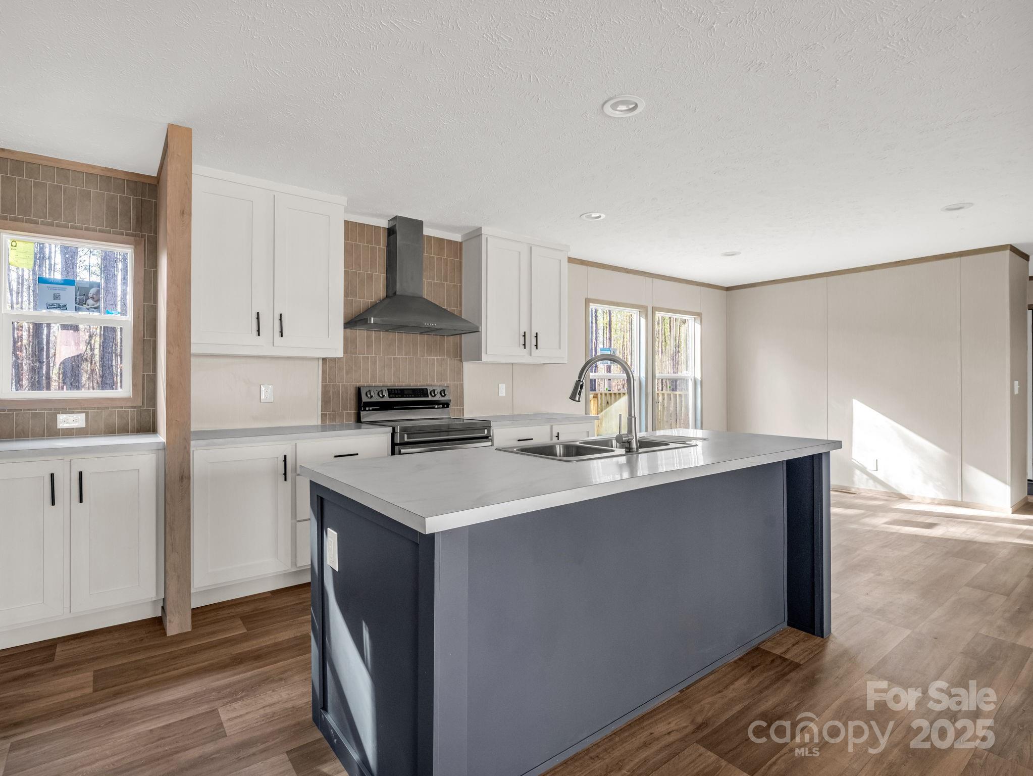 864 Tiney Road Ellenboro, NC 28040 - Photo 10 of 33 a kitchen with stainless steel appliances a sink and a refrigerator