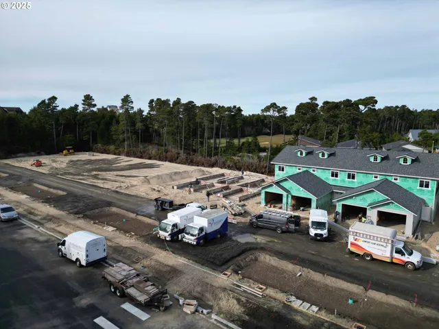 an aerial view of multiple houses with a yard